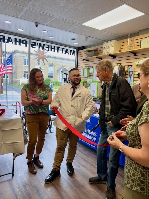 Owners cutting the ribbon on the remodeled pharmacy